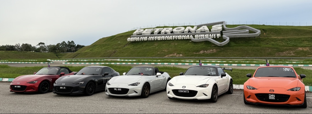 Five Mazda MX-5s lined up in formation at Sepang International Circuit
