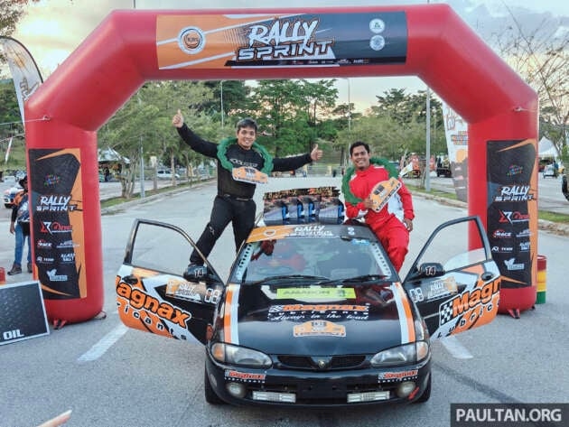 Mitch celebrating victory on top of the Satria at Rally Sprint finish arch
